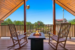 Rock gently in your chair by the fire pit while soaking in mountain views and crisp, fresh air from this covered terrace—your perfect retreat for morning coffee or evening stargazing.