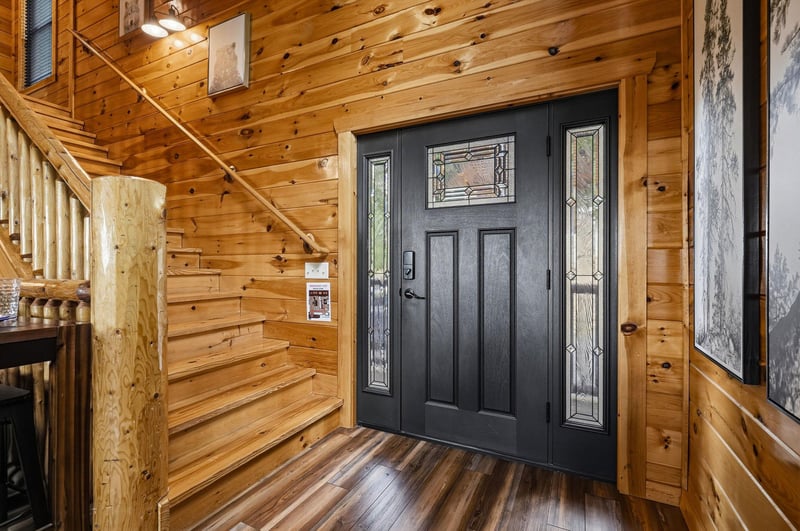 The propertys entrance welcomes guests with elegant decorative glass panels and warm natural wood throughout, setting the tone for your mountain getaway.