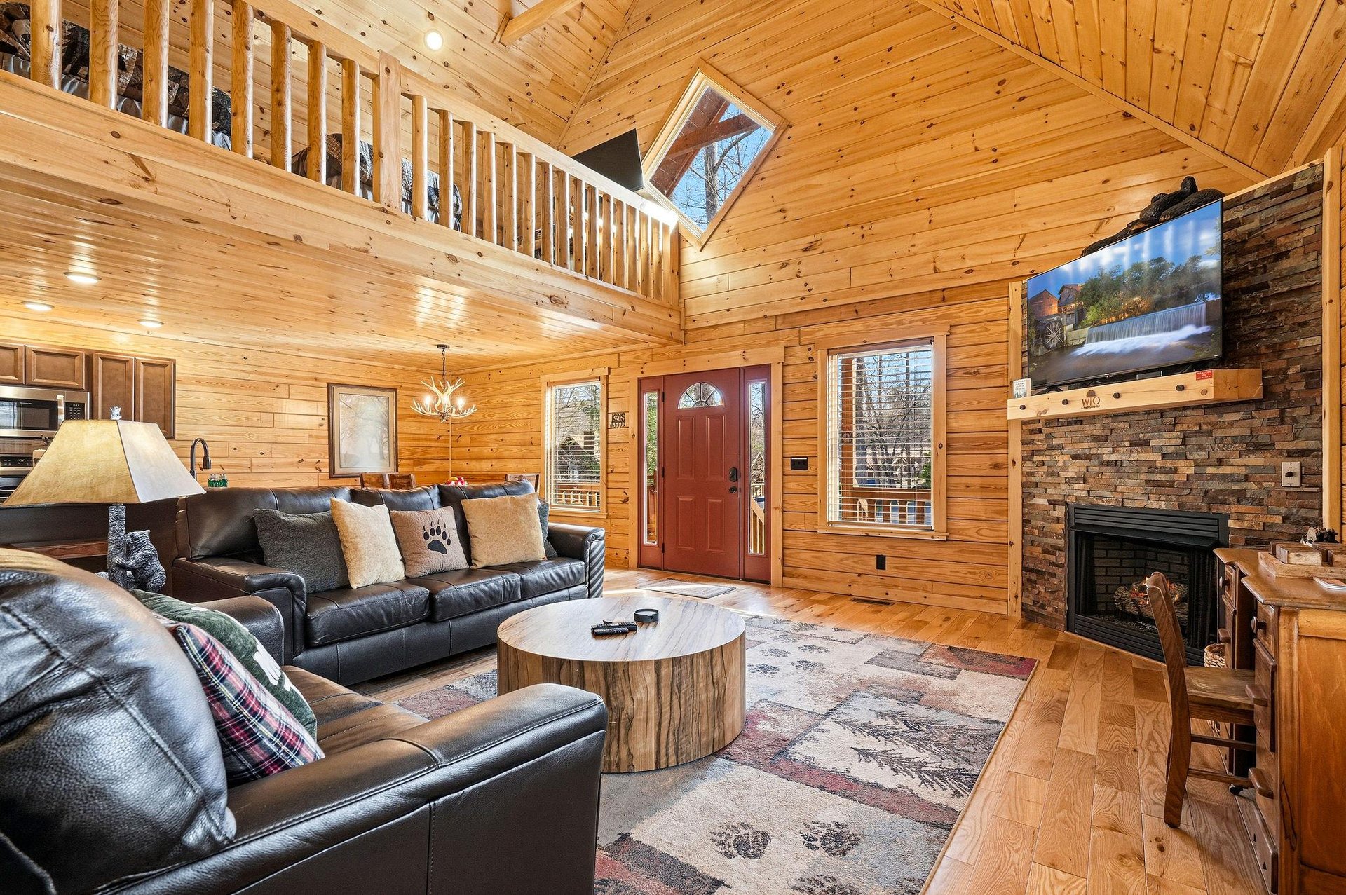 Relax in your cozy cabin living room with plush leather seating, crackling fireplace, and rustic wood details creating the perfect mountain retreat atmosphere.