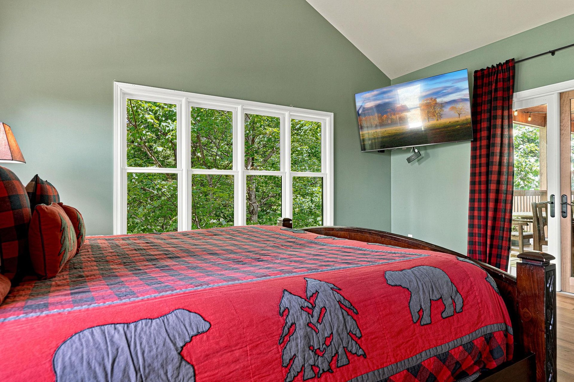 Wake up to lush forest views through oversized windows that bring nature right to your bedside, with a cozy retreat that blends rustic charm and modern comfort.