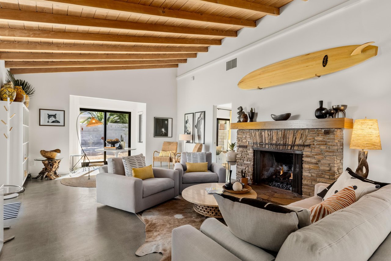 Exposed beams and stone fireplace
