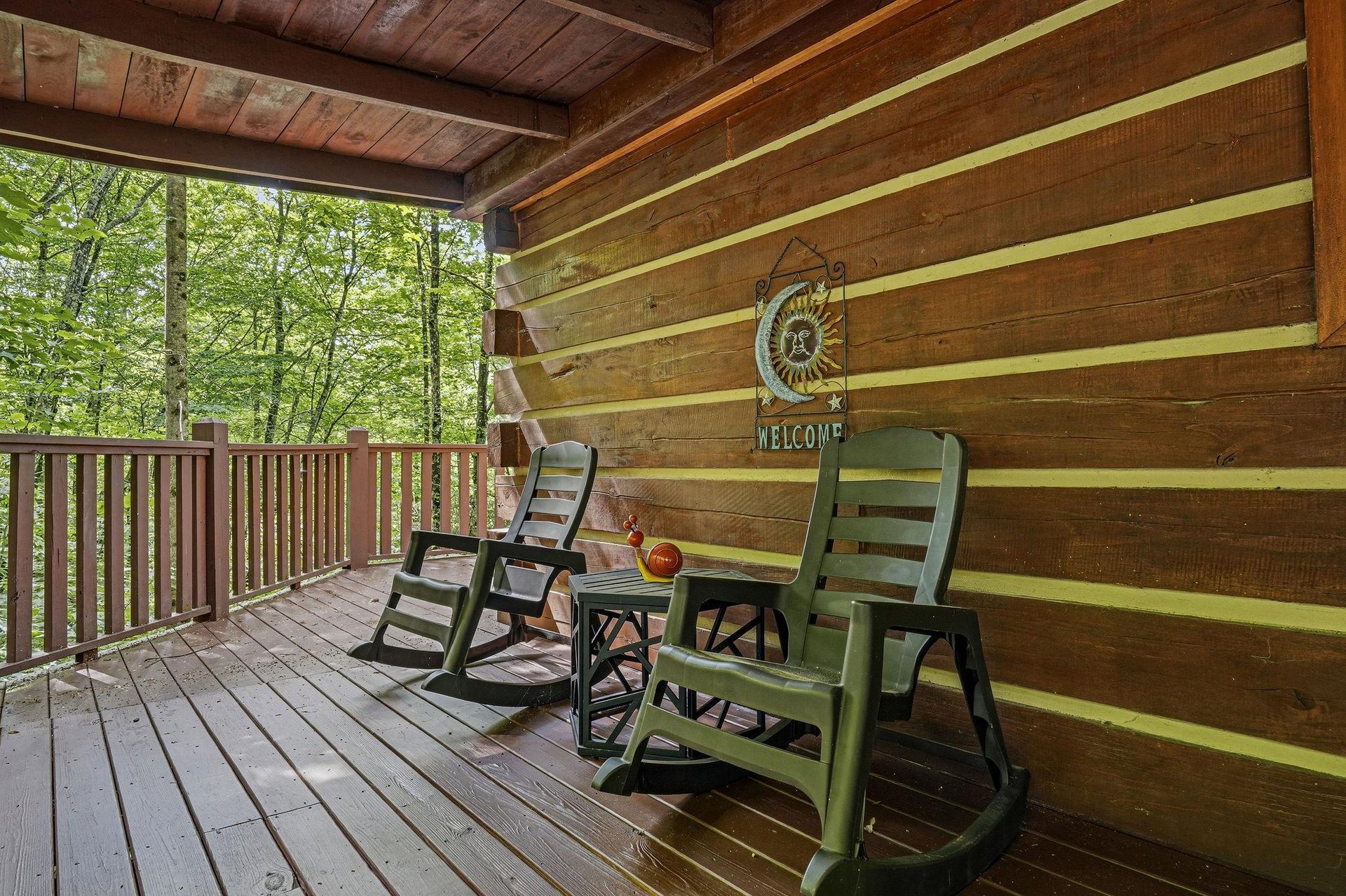 Your covered deck invites you to unwind in rocking chairs, overlooking serene woods where birdsong fills the air and fresh breezes bring pure relaxation.