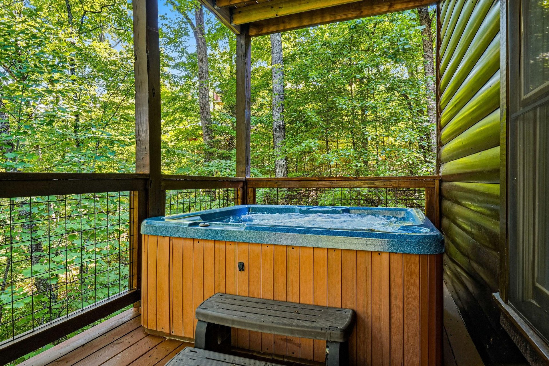 Unwind in your private hot tub surrounded by lush forest canopy—your peaceful escape where bubbling water meets rustling leaves and birdsong.