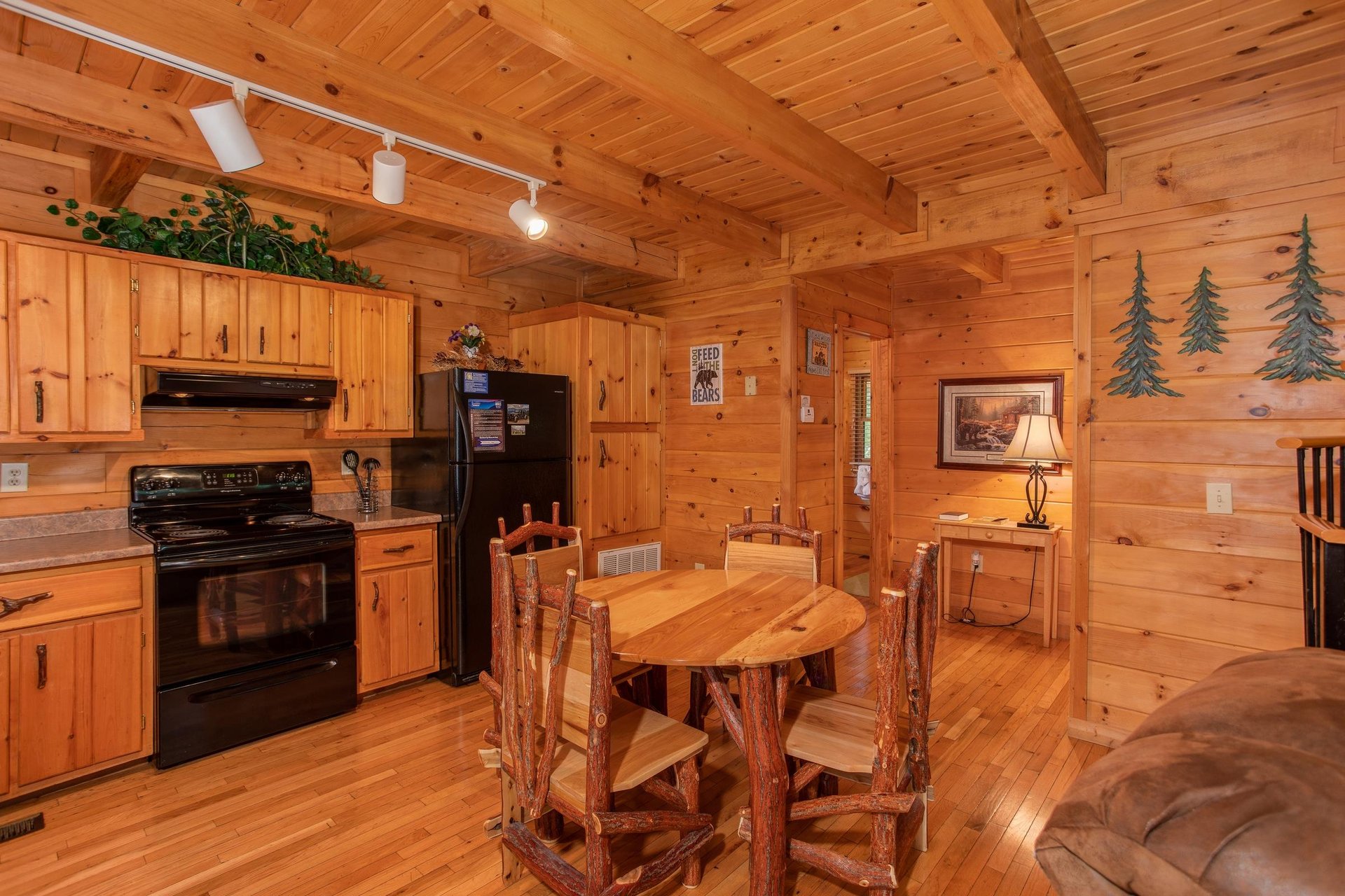 Dining space for four in the kitchen with black appliances at Dreams Do Come True, a 1bedroom cabin rental located in Pigeon Forge