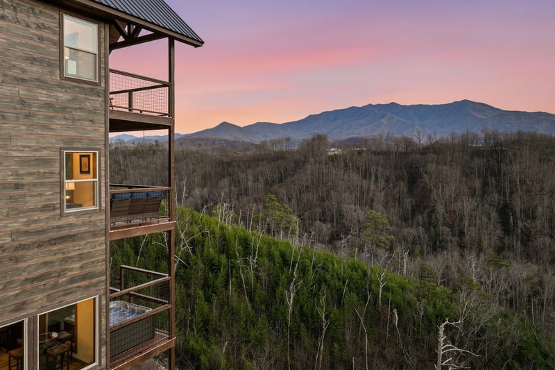 Stunning mountain views frame this propertys multilevel balconies as sunset paints the sky in brilliant hues.