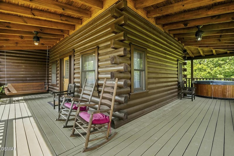 Settle into a rocking chair on your expansive covered deck, where warm wood tones and a porch swing invite you to slow down and savor the mountain air.