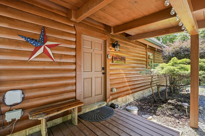 The warm, woodsided cabin entrance greets you with rustic charm and thoughtful touches, hinting at the cozy retreat waiting inside.