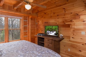 Console table and TV in a bedroom at EllaVation, a 3 bedroom cabin rental located in Gatlinburg