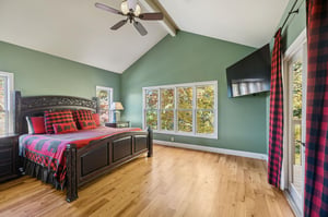 Wake up refreshed in this inviting bedroom with vaulted ceilings, bright natural light, and a cozy retreat feel. Your private balcony door leads to fresh morning air and treelined views.