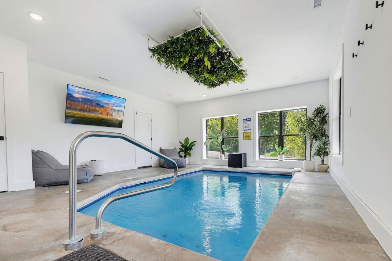 Imagine unwinding in your own private indoor pool, surrounded by greenery and natural light streaming through bright windows—a serene escape after a day of adventure.