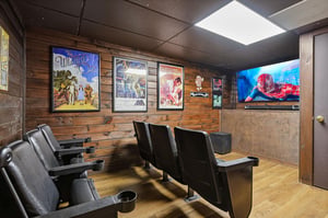 Your own private theater awaits—plush cinema seats, vintage movie posters, and a big screen ready for movie marathons and game nights.
