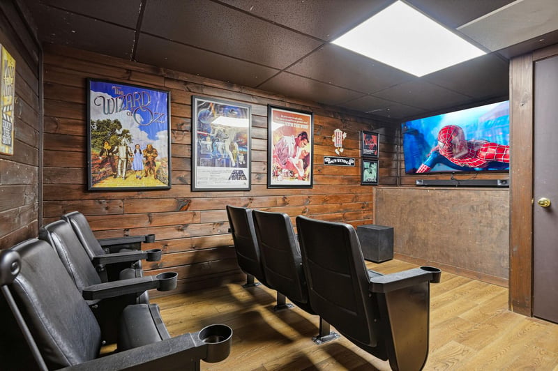 Your own private theater awaits—plush cinema seats, vintage movie posters, and a big screen ready for movie marathons and game nights.