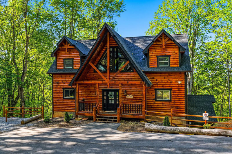 Beautiful log cabin surrounded by lush forest, featuring rustic wood architecture and peaceful mountain retreat atmosphere.