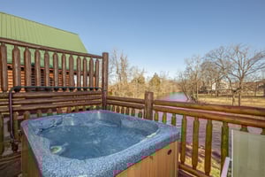 Hot tub overlooking the river at Gone Fishin, a 2bedroom cabin rental located in Pigeon Forge