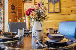 Gather around your beautifully set dining table, where rustic charm meets elegant touches for memorable meals together.