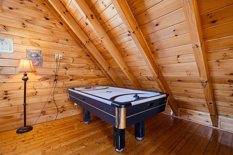 Spend your evenings playing air hockey in this cozy loft tucked beneath beautiful woodbeam ceilings—its perfect for a little friendly competition.