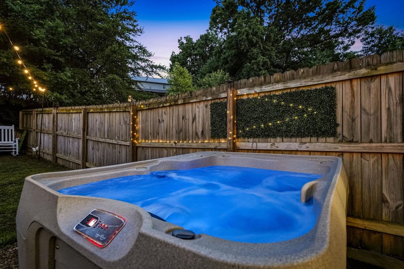 Soak away the day in your private hot tub, surrounded by twinkling lights and lush greenery for the ultimate evening escape.
