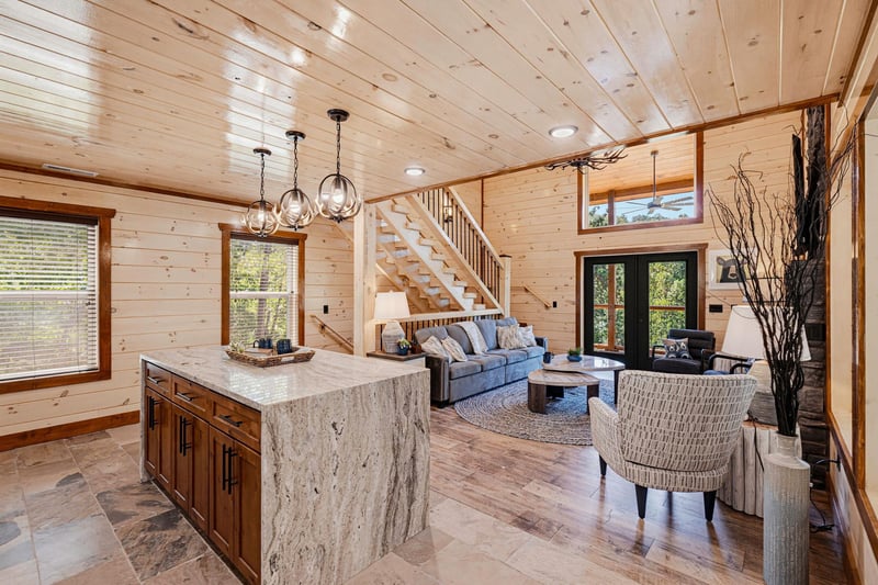 Bright openconcept living with vaulted ceilings and pine walls. The kitchen island is perfect for gathering while preparing meals and enjoying time with loved ones.