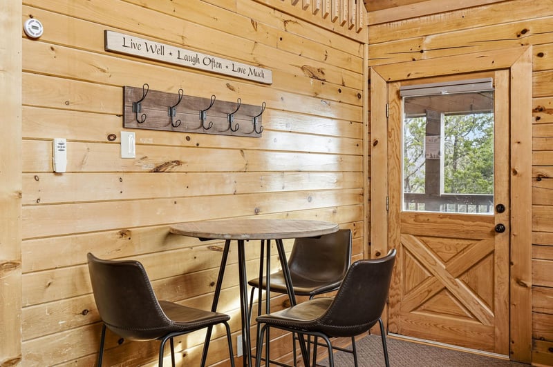 Step into your cozy dining nook with rustic charm—warm wood walls, inspiring quotes, and a perfect spot for morning coffee or evening meals.