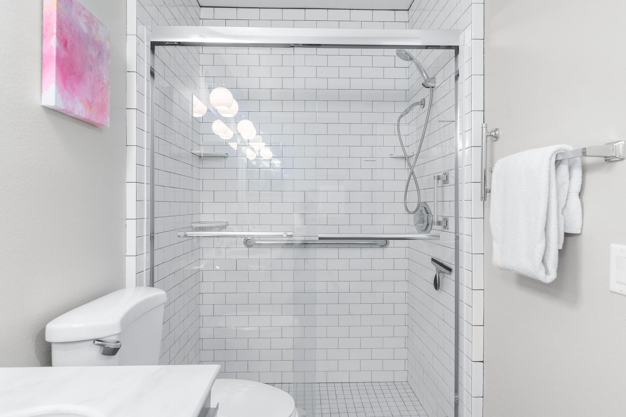 Ensuite bathroom with dual vanity sinks and walkin shower.