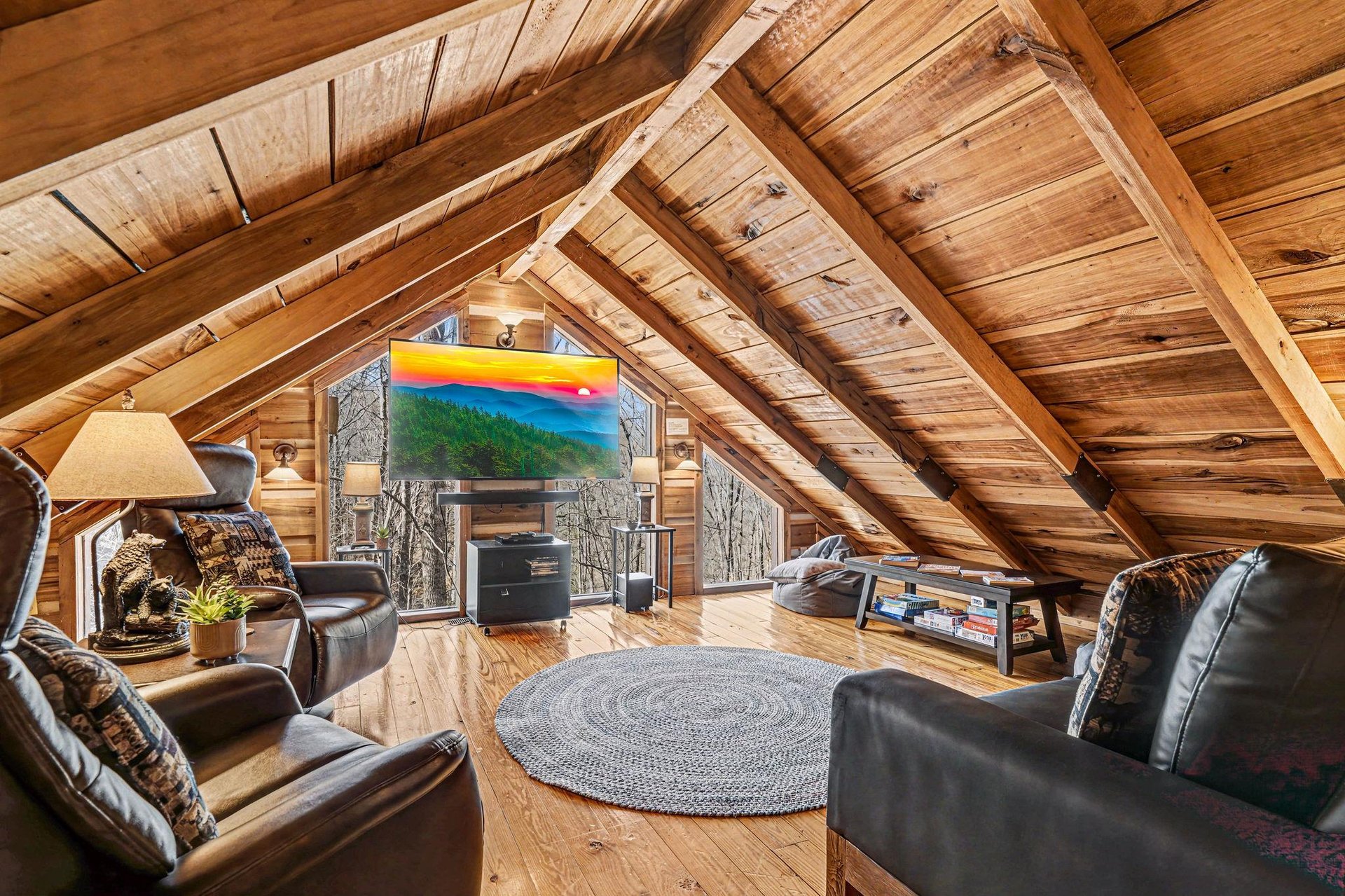 Cozy up in your private loft retreat with exposed beams, plush leather seating, and a large TV for movie nights under the stars.