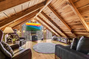Cozy up in your private loft retreat with exposed beams, plush leather seating, and a large TV for movie nights under the stars.
