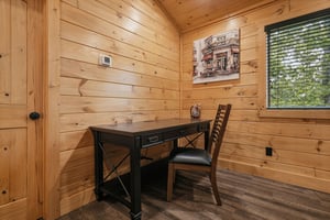 Your private workspace combines rustic charm with modern comfort, featuring warm wood walls and natural light for productive moments.