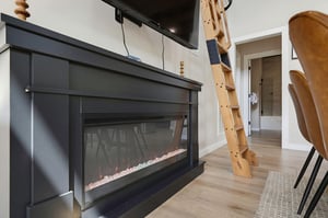 Cozy up by your modern electric fireplace, a stylish focal point for relaxing evenings after your adventures. The unique ladder adds charm and leads to extra sleeping space above.