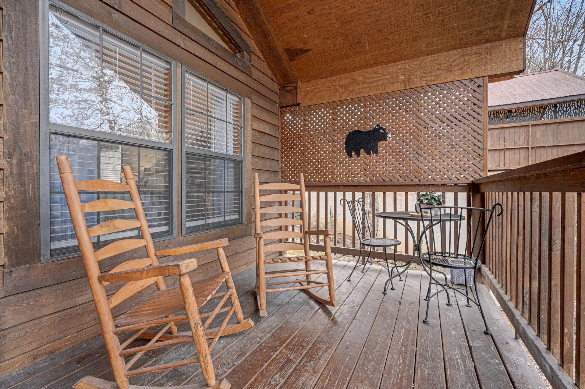 Unwind on your private covered deck with rustic rocking chairs and charming bistro dining—perfect for morning coffee or evening relaxation.