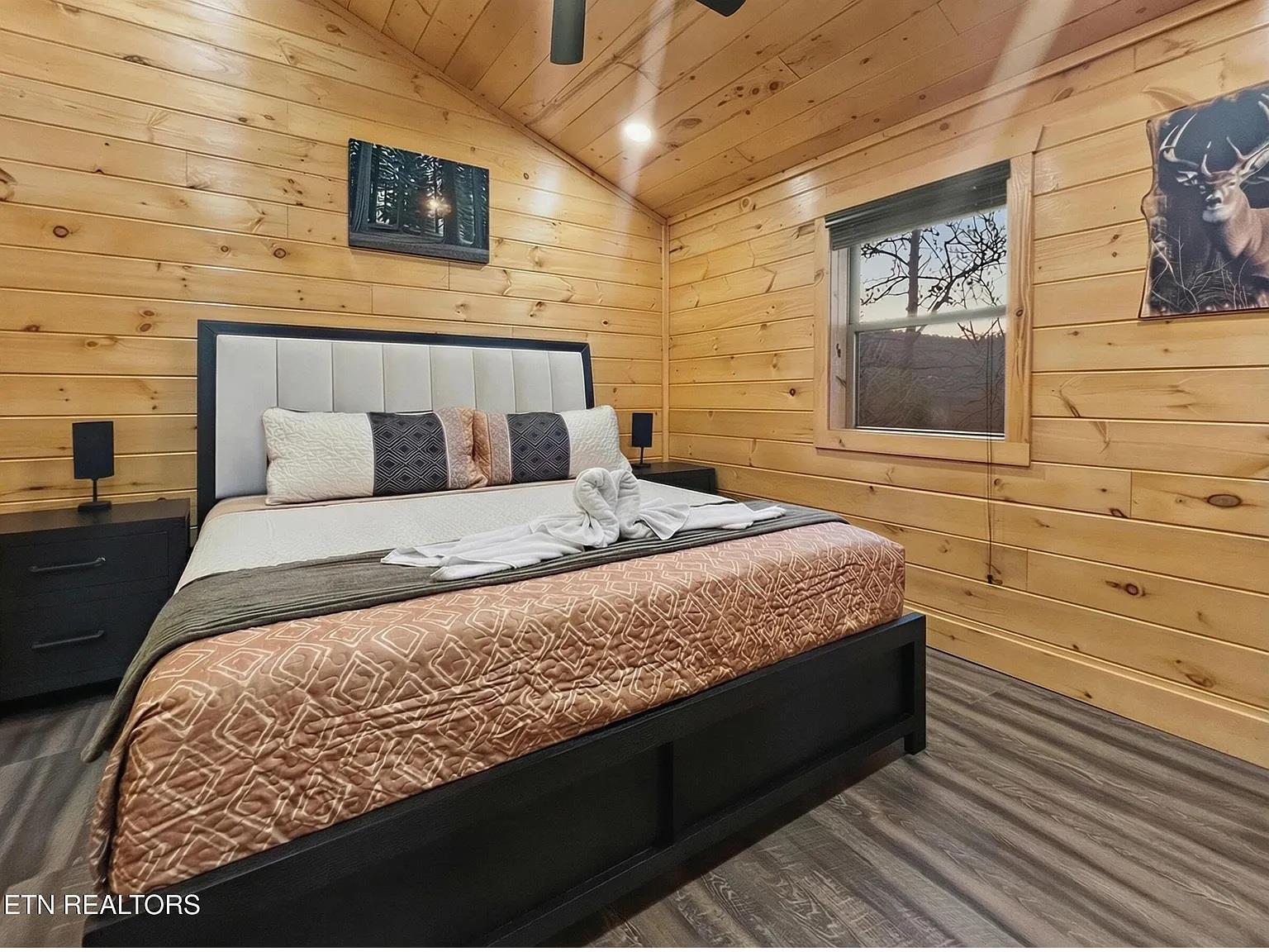 Drift off to sleep in your cozy log cabin bedroom, where warm wood walls and rustic charm create the perfect mountain retreat atmosphere.