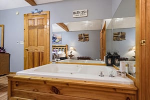 Slip into your spacious jetted tub and let the warm water ease away the day, surrounded by rustic pine and cozy touches that make this retreat feel like home.