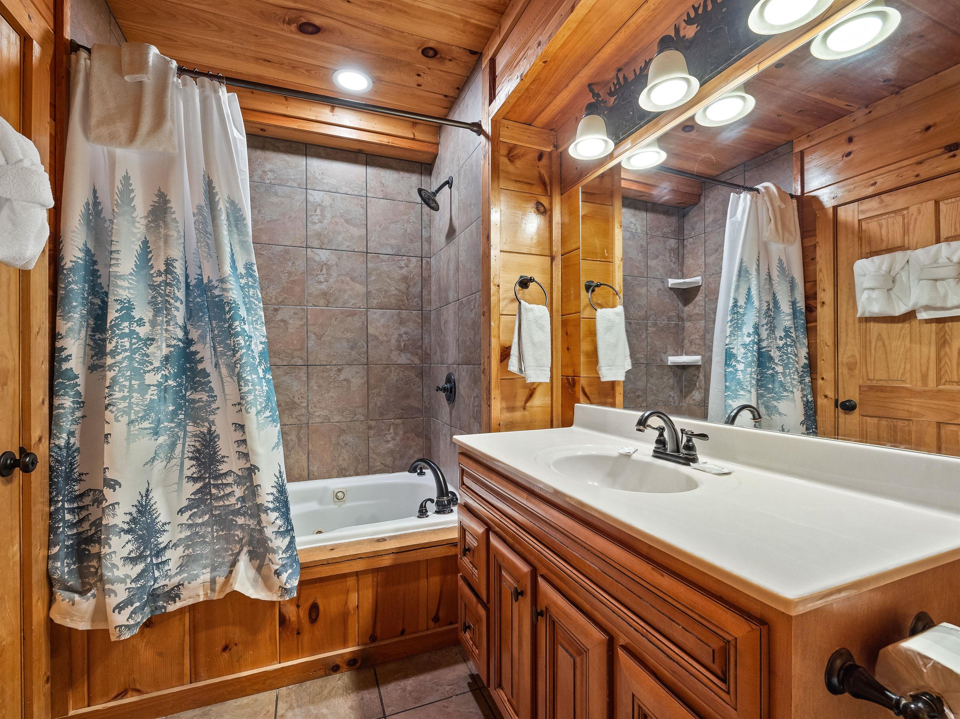 Full bathroom with long single vanity sink and bathtub