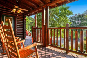 Sink into the rocking chair on your private covered porch and take in the lush treetops and peaceful natural surroundings—perfect for morning coffee or quiet evenings under the open sky.