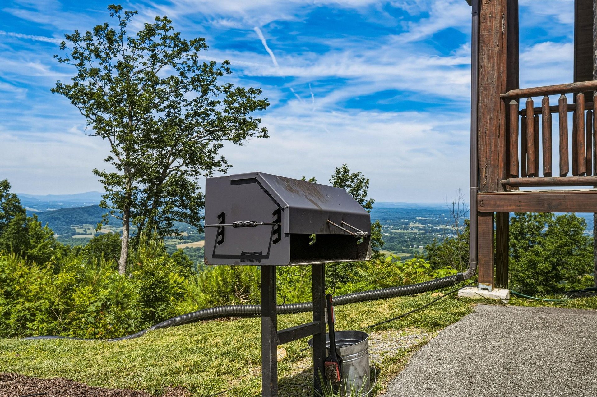 Enjoy mountain views and fresh air while grilling outdoors on the expansive grounds, surrounded by rolling hills and bright summer skies.