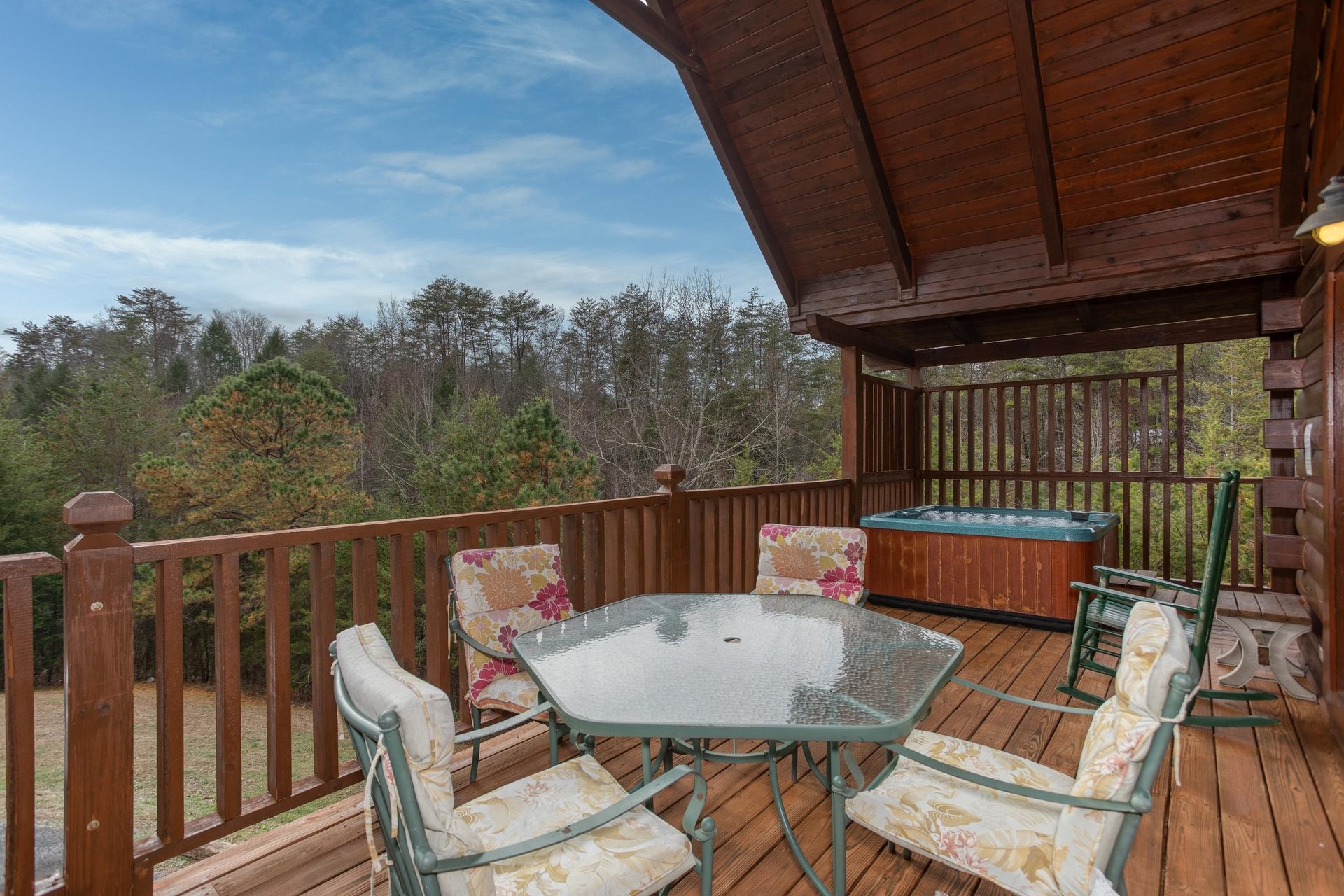 Covered deck with dining table for four at Hibernation Station, a 3bedroom cabin rental located in Pigeon Forge