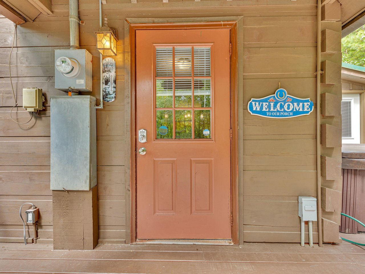 Charming entrance welcomes you to your porch retreat with rustic cabin charm and thoughtful details.