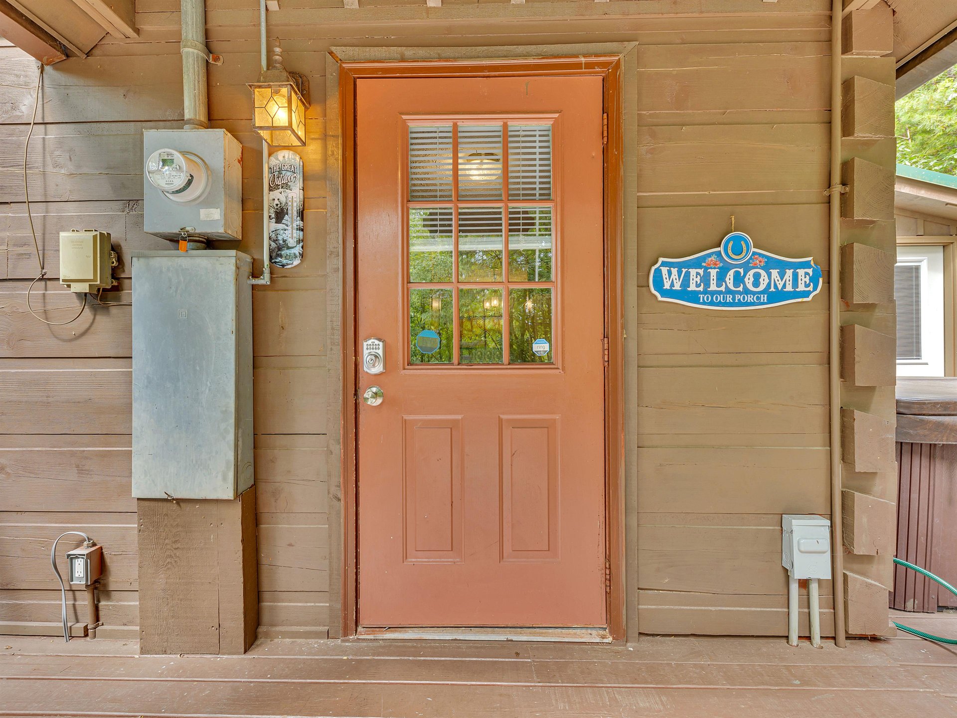 Charming entrance welcomes you to your porch retreat with rustic cabin charm and thoughtful details.