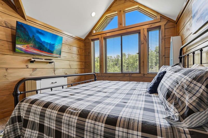 Wake up to stunning mountain views from your cozy loft bedroom, complete with warm wood walls and modern entertainment.