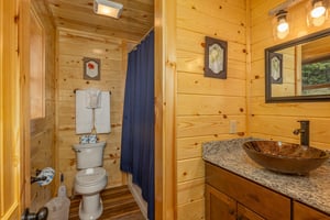 Bathtub with divider wall to single vanity sink