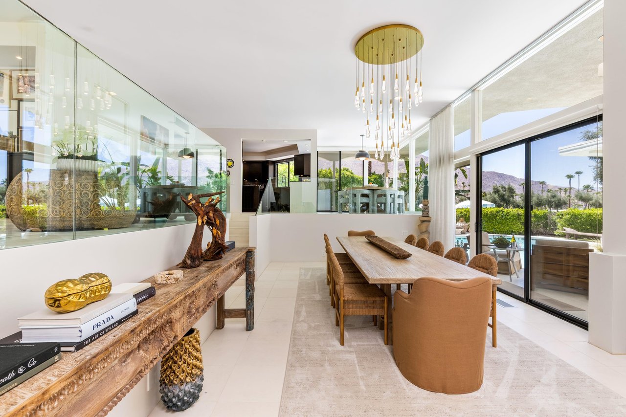 Dining room has a table and chairs for up to 12 guests. Pool views can be seen from the dining space.