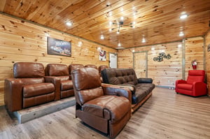 Sink into plush leather recliners in your private theater room, complete with rustic wood walls and cozy lighting for unforgettable movie nights.