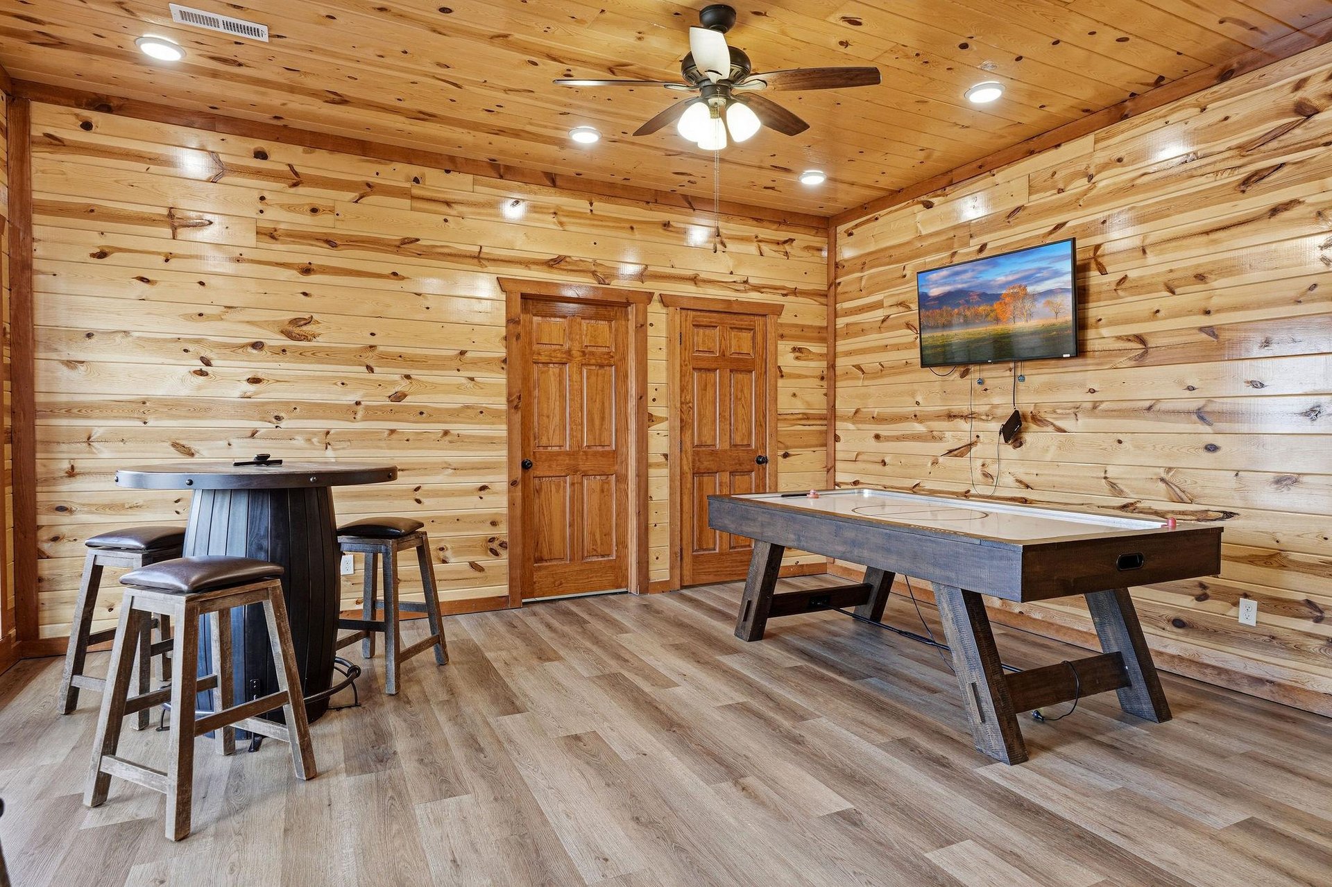 Your rustic game room awaits with air hockey and hightop seating surrounded by warm knotty pine walls.