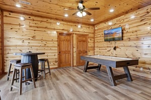 Your rustic game room awaits with air hockey and hightop seating surrounded by warm knotty pine walls.