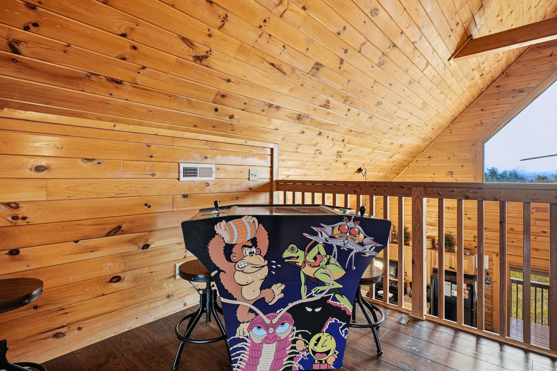 Unwind on your private covered balcony with cozy seating, where warm wood surroundings create the perfect retreat for morning coffee or evening relaxation.