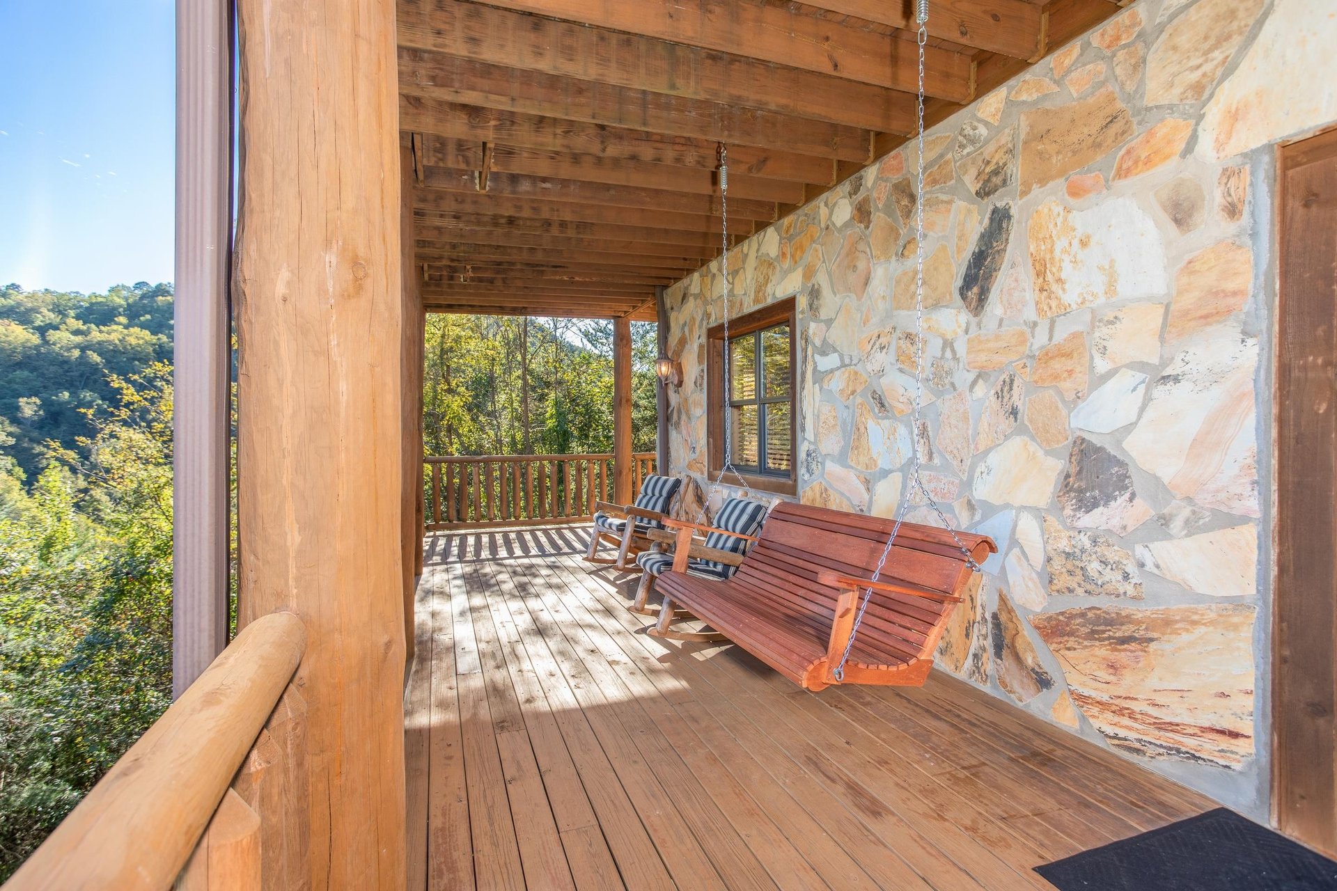 Swing on the lower deck at Great View Lodge, a 5bedroom cabin rental located in Pigeon Forge