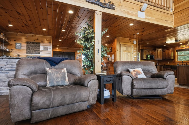 Sink into plush recliners and let the warm glow of the fireplace melt away your stress. Rich wood tones and soaring ceilings create a cozy retreat perfect for your mountain getaway.