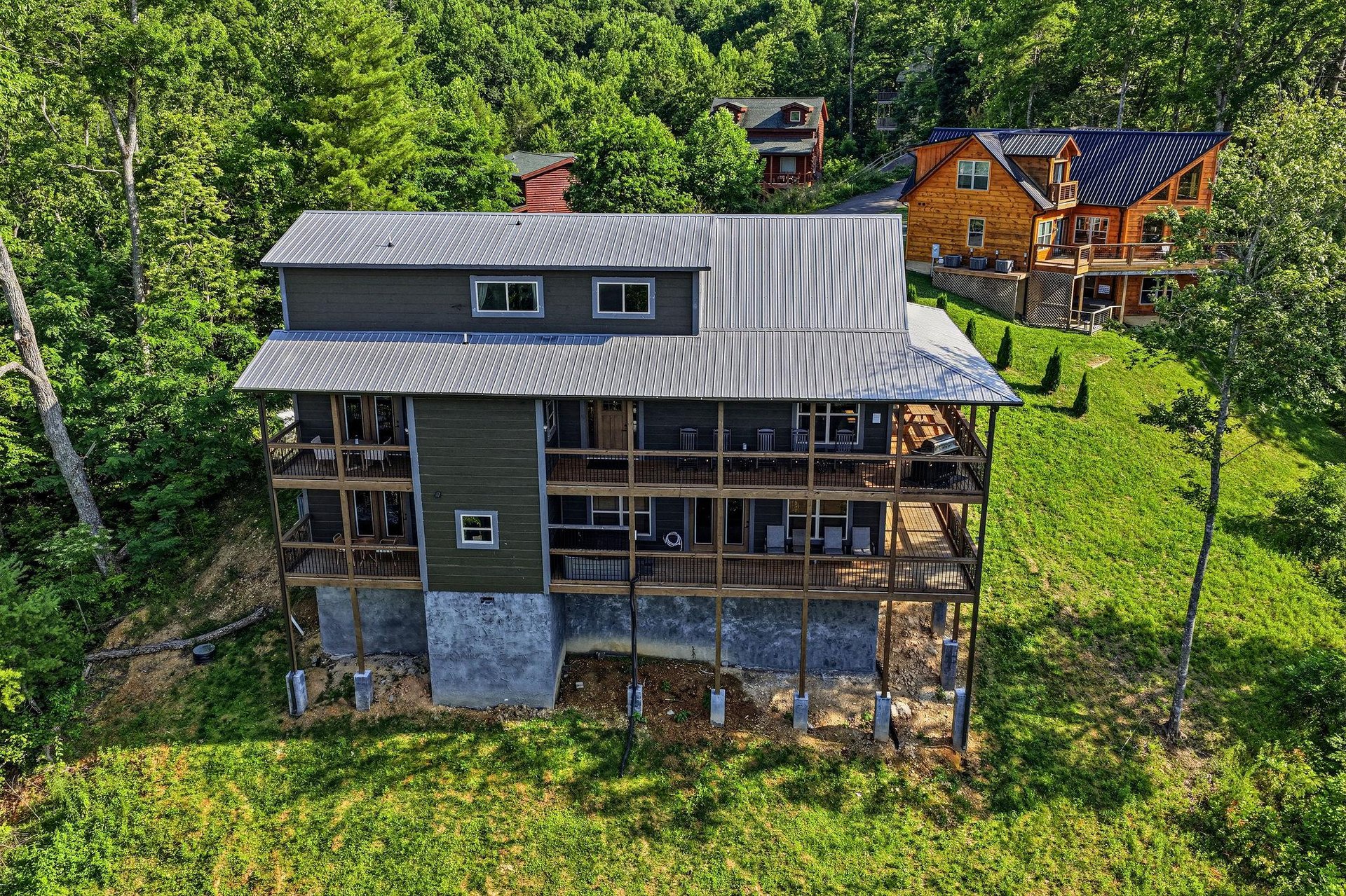 Charming mountain retreat nestled among lush trees with wraparound decks perfect for morning coffee and stargazing. Natural privacy in a wooded hillside setting close to neighboring cabins.