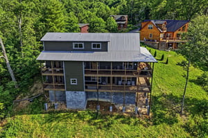 Charming mountain retreat nestled among lush trees with wraparound decks perfect for morning coffee and stargazing. Natural privacy in a wooded hillside setting close to neighboring cabins.