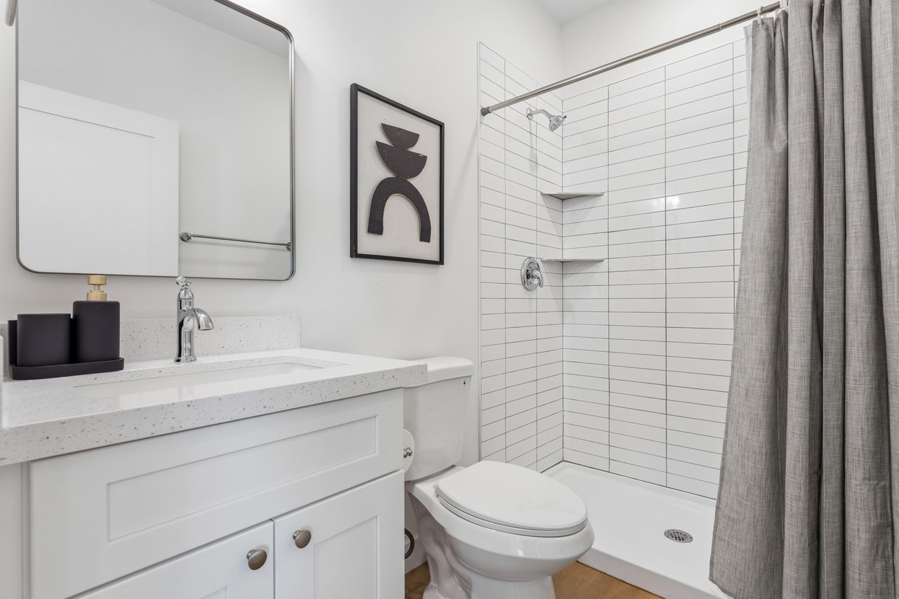 Guest bathroom with stand alone shower and modern fixtures.
