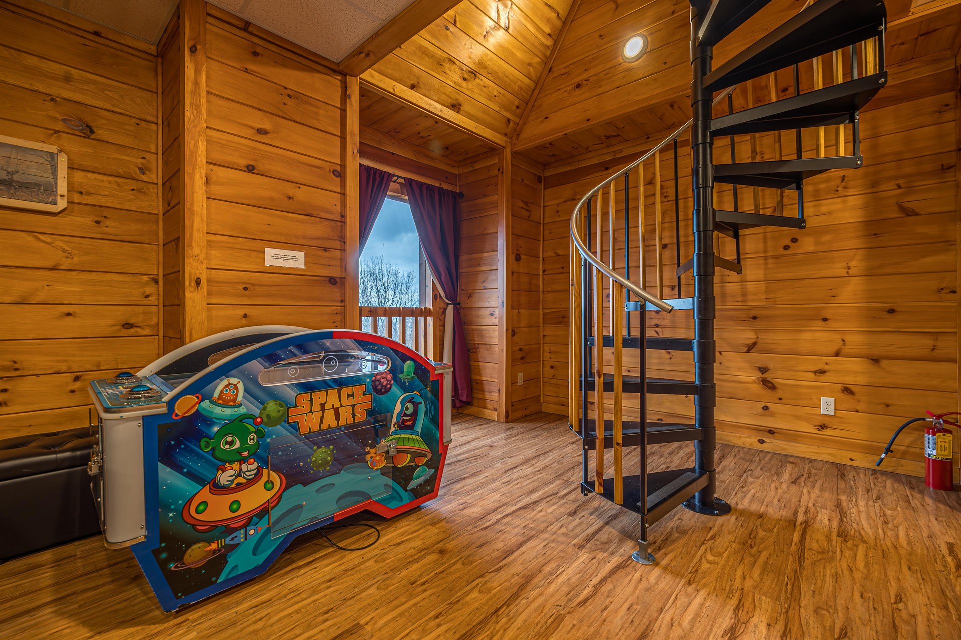 Arcade and staircase at Eagles Sunrise, a 2 bedroom cabin rental located in Pigeon Forge